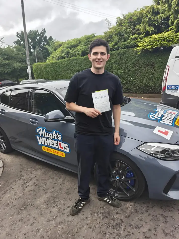 Andrew celebrating passing their driving test with Hugh's Wheels