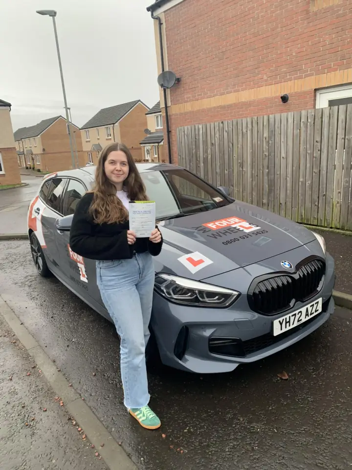 Caitlin celebrating passing their driving test with Hugh's Wheels