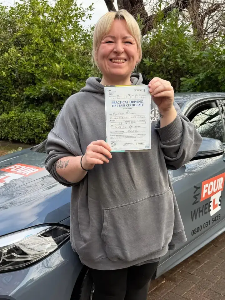 Cheryl celebrating passing their driving test with Hugh's Wheels