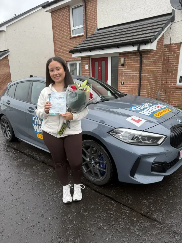 Emeleigh celebrating passing their driving test with Hugh's Wheels
